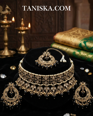 Luxury black and gold Kundan bridal necklace set featuring intricate floral detailing with matching earrings and maang tikka, an elegant statement piece for South Asian weddings and formal occasions
