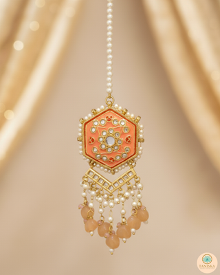 Luxury peach-orange meenakari Kundan choker necklace set with matching jhumka earrings and maang tikka, vibrant statement jewelry for South Asian bridal weddings and festive occasions.