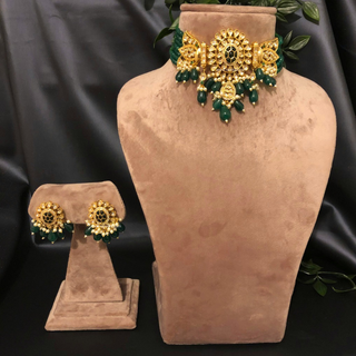 Luxury green emerald beaded Kundan choker set with matching earrings, an elegant statement piece for South Asian bridal weddings and nikah ceremonies, as seen in www.taniska.com