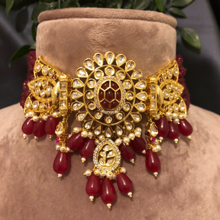 Luxury maroon beaded Kundan choker necklace set with matching earrings worn by a model, perfect for South Asian weddings and bridal receptions.
