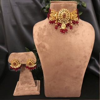 Luxury maroon beaded Kundan choker necklace set with matching earrings worn by a model, perfect for South Asian weddings and bridal receptions.
