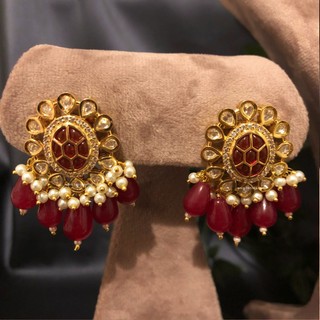 Luxury maroon beaded Kundan choker necklace set with matching earrings worn by a model, perfect for South Asian weddings and bridal receptions.
