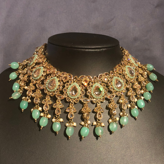 Luxury mint green Kundan bridal necklace set with matching jhumka earrings and maang tikka, elegant statement jewelry for South Asian weddings and nikah ceremonies.