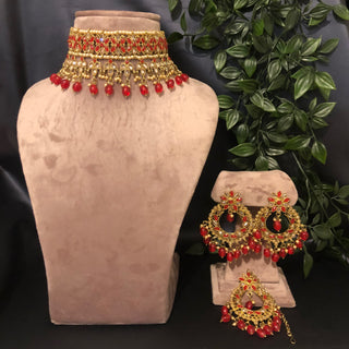 Luxury red and gold Kundan bridal necklace set with matching earrings and maang tikka, statement jewelry for South Asian weddings and nikah ceremonies.
