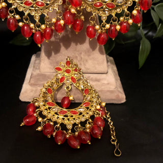 Luxury red and gold Kundan bridal necklace set with matching earrings and maang tikka, statement jewelry for South Asian weddings and nikah ceremonies.